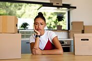 Woman looking tired and stressed with belongings